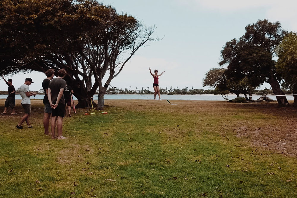 Female slackliner walking in Zandvlei