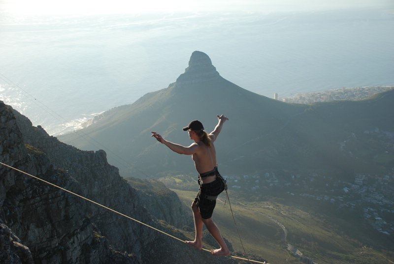 Athlete walks highline in front of Lions Head