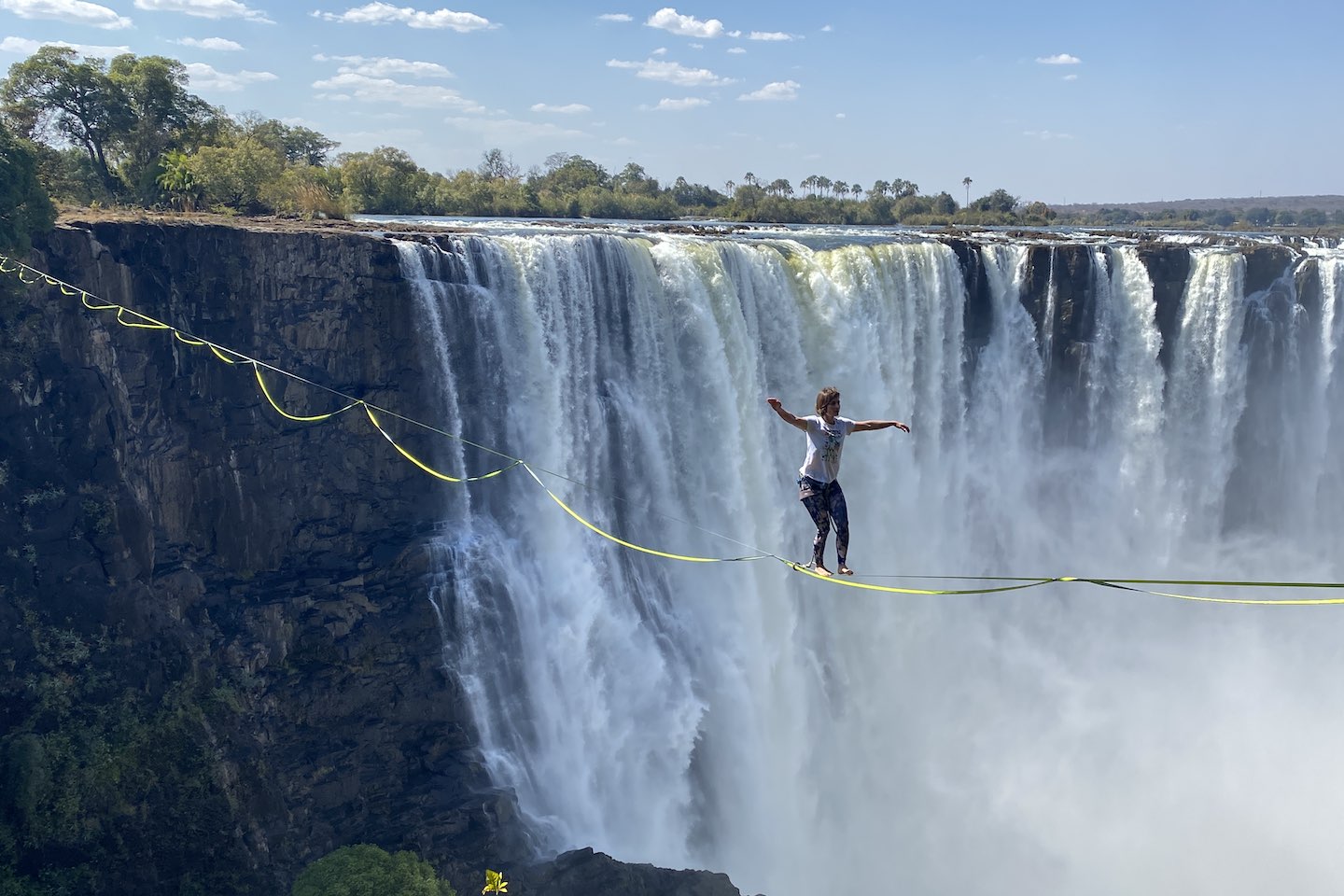 Antonia walking across the Victoria Falls on a highline