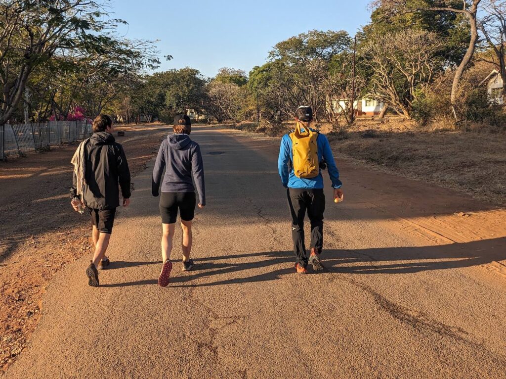 Laurence, Antonia, and Lukas walking in Victoria Falls