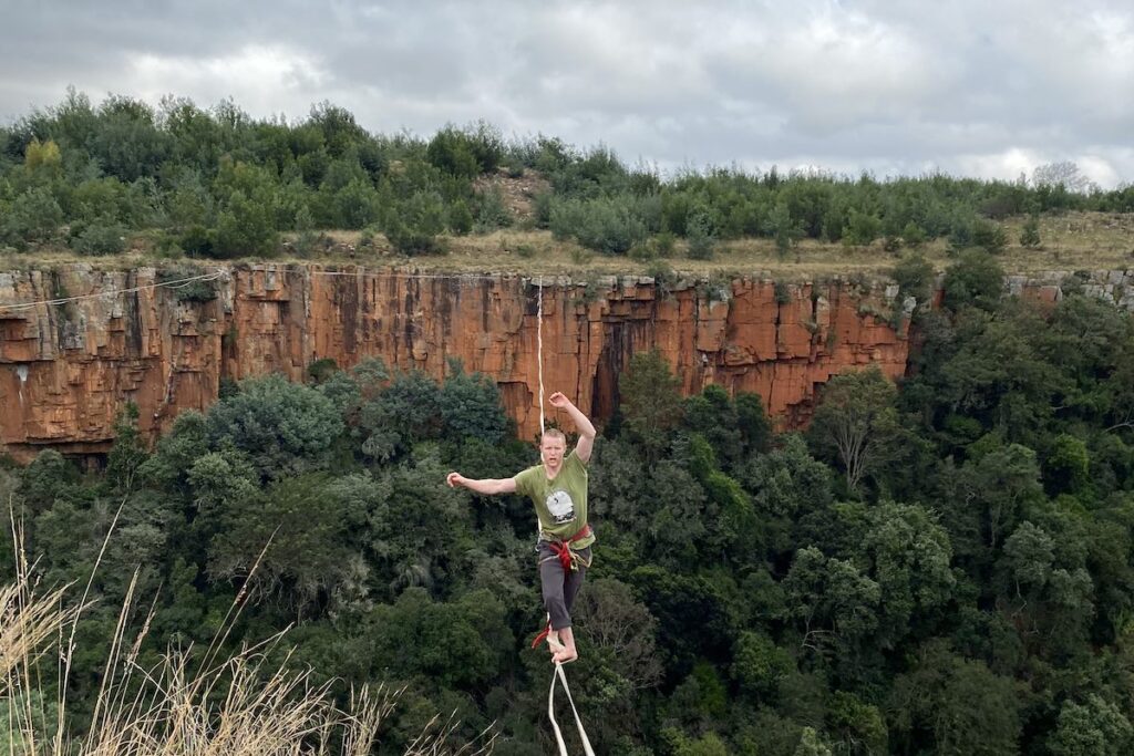 Tim crossing a highline in Waterval Boven